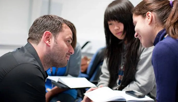 Teacher helping students